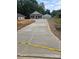 Newly poured concrete driveway leads to a charming single-story home, surrounded by green landscaping at 812 Generation Ln, Clover, SC 29710