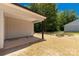 Cozy covered patio area perfect for outdoor relaxation with a view of the backyard and mature trees at 812 Generation Ln, Clover, SC 29710