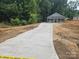 Newly constructed single-Gathering home with a concrete driveway, offering a modern and inviting facade at 814 Generation Ln, Clover, SC 29710