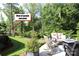 Backyard with outdoor seating area, mature trees, and view of a gazebo and pond at 914 Greenbridge Dr, Matthews, NC 28105