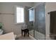 Bathroom featuring a glass enclosed shower, and white tile throughout the space at 914 Greenbridge Dr, Matthews, NC 28105