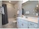 Bright bathroom with a white vanity, large mirror, and shower-tub combo at 914 Greenbridge Dr, Matthews, NC 28105