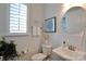 Clean bathroom features a modern vanity, framed mirror, toilet, and window with wooden blinds at 914 Greenbridge Dr, Matthews, NC 28105