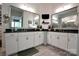 Bathroom with dual sinks, white cabinetry, and a large vanity mirror at 914 Greenbridge Dr, Matthews, NC 28105