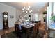 Elegant dining area adjacent to a modern kitchen and staircase, creating a warm ambiance at 914 Greenbridge Dr, Matthews, NC 28105