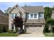 Charming two-story home featuring a brick facade, attached garage, and beautifully landscaped front yard at 914 Greenbridge Dr, Matthews, NC 28105