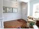 Welcoming foyer featuring hardwood floors, wainscoting, a cozy chair, and decorative artwork at 914 Greenbridge Dr, Matthews, NC 28105