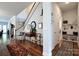 Inviting foyer featuring hardwood floors, staircase, and a hallway bench with storage hooks at 914 Greenbridge Dr, Matthews, NC 28105