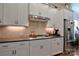Modern kitchen showcasing stainless steel appliances, tile backsplash, and sleek white cabinetry at 914 Greenbridge Dr, Matthews, NC 28105