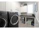 Well-equipped laundry room featuring modern washer and dryer, cabinets, and countertop space at 914 Greenbridge Dr, Matthews, NC 28105