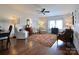 Cozy living room with hardwood floors, a ceiling fan, and multiple seating areas for relaxing at 914 Greenbridge Dr, Matthews, NC 28105