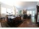 Open floorplan with dining and living area, stone fireplace, and hardwood floors at 914 Greenbridge Dr, Matthews, NC 28105