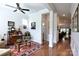 Inviting living room with hardwood floors, a ceiling fan, and a hallway with views into other rooms at 914 Greenbridge Dr, Matthews, NC 28105