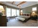 Bright bedroom with exposed beams, large windows, and elegant chandelier at 914 Greenbridge Dr, Matthews, NC 28105