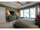 Bedroom with beam ceilings, large windows, dresser, and sitting chair at 914 Greenbridge Dr, Matthews, NC 28105