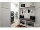 Functional mud room with a built-in bench, storage shelves, and modern washer and dryer at 914 Greenbridge Dr, Matthews, NC 28105