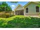 The backyard features mature trees and green grass, a screened porch, and a deck at 9330 Carneros Creek Rd, Charlotte, NC 28214