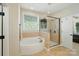 Bright bathroom featuring a soaking tub, glass shower, and decorative window at 9330 Carneros Creek Rd, Charlotte, NC 28214