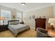 Comfortable bedroom with two bright windows, lamps, and a dark wood dresser at 9330 Carneros Creek Rd, Charlotte, NC 28214