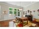 Bright dining room with large windows, hardwood floors, and a modern chandelier for a pleasant dining experience at 9330 Carneros Creek Rd, Charlotte, NC 28214
