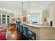 Open kitchen featuring a granite countertop bar, stylish seating, and a seamless transition to the dining area at 9330 Carneros Creek Rd, Charlotte, NC 28214