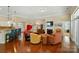 Open living space featuring a fireplace, hardwood floors, and a seamless flow into the kitchen area at 9330 Carneros Creek Rd, Charlotte, NC 28214