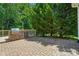 Outdoor stone grill and cooking area on a brick patio with trees surrounding the outdoor living space at 9330 Carneros Creek Rd, Charlotte, NC 28214