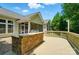 Outdoor stone grill and cooking area on a patio and deck with trees surrounding the outdoor living space at 9330 Carneros Creek Rd, Charlotte, NC 28214