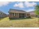 A beautiful brick home with an enclosed patio and a neatly kept lawn at 9662 Liberty Hill Dr, Mint Hill, NC 28227