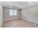 Spacious bedroom with tray ceiling, hardwood floors, and natural light at 9662 Liberty Hill Dr, Mint Hill, NC 28227