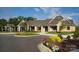 A beautiful brick clubhouse with a parking lot in the foreground and flowers planted on the grounds at 9662 Liberty Hill Dr, Mint Hill, NC 28227