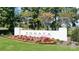 Elegant community entrance with vibrant floral landscaping and stately signage, creating a welcoming first impression at 9662 Liberty Hill Dr, Mint Hill, NC 28227