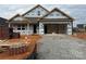 New construction home with exposed framework, materials, and an open garage, set on a construction site at 9662 Liberty Hill Dr, Mint Hill, NC 28227