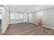 Bright living room with wood flooring, neutral paint, and windows, offering a view to the outdoors at 9662 Liberty Hill Dr, Mint Hill, NC 28227