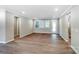 Spacious living room with neutral walls, wood flooring, and abundant natural light from large windows at 9662 Liberty Hill Dr, Mint Hill, NC 28227