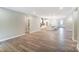 Open living space with light wood floors connecting to kitchen, showcasing an open-concept design at 9662 Liberty Hill Dr, Mint Hill, NC 28227