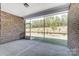 This is an enclosed patio with brick columns and walls and a full view of the outdoor scenery with a concrete floor at 9662 Liberty Hill Dr, Mint Hill, NC 28227