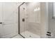 Sleek walk-in shower with frameless glass door, rain shower head, and tiled walls at 9662 Liberty Hill Dr, Mint Hill, NC 28227