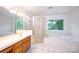 Bathroom features a soaking tub, glass-enclosed shower, and vanity with double sinks at 10408 Hadleigh Pl, Charlotte, NC 28210