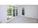 Sun-filled bedroom with neutral carpet, trim, and large windows at 10408 Hadleigh Pl, Charlotte, NC 28210