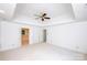 Primary bedroom offers a ceiling fan, neutral carpet and tray ceiling at 10408 Hadleigh Pl, Charlotte, NC 28210