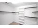 Organized walk-in closet with shelving and rods for ample storage space at 10408 Hadleigh Pl, Charlotte, NC 28210