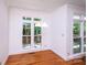 Bright dining room with hardwood floors, white trim, and windows overlooking the deck at 10408 Hadleigh Pl, Charlotte, NC 28210
