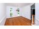 Bright dining room with hardwood floors, chandelier, and large windows at 10408 Hadleigh Pl, Charlotte, NC 28210