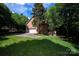 View of the exterior of the brick home with a garage, lawn, and a driveway at 10408 Hadleigh Pl, Charlotte, NC 28210