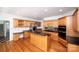 Spacious kitchen features wood cabinets, stainless steel appliances, and a granite-topped island at 10408 Hadleigh Pl, Charlotte, NC 28210