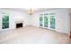 Living room with fireplace, neutral carpet and access to an outdoor balcony at 10408 Hadleigh Pl, Charlotte, NC 28210
