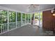 Spacious screened in porch with ceiling fan and exterior brick wall at 10408 Hadleigh Pl, Charlotte, NC 28210