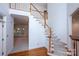 Staircase featuring wood and carpet steps and white wood railing and trim at 10408 Hadleigh Pl, Charlotte, NC 28210