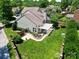 Aerial view showcasing the brick perimeter of the backyard, lush green lawn, and pergola at 10418 Pullengreen Dr, Charlotte, NC 28277